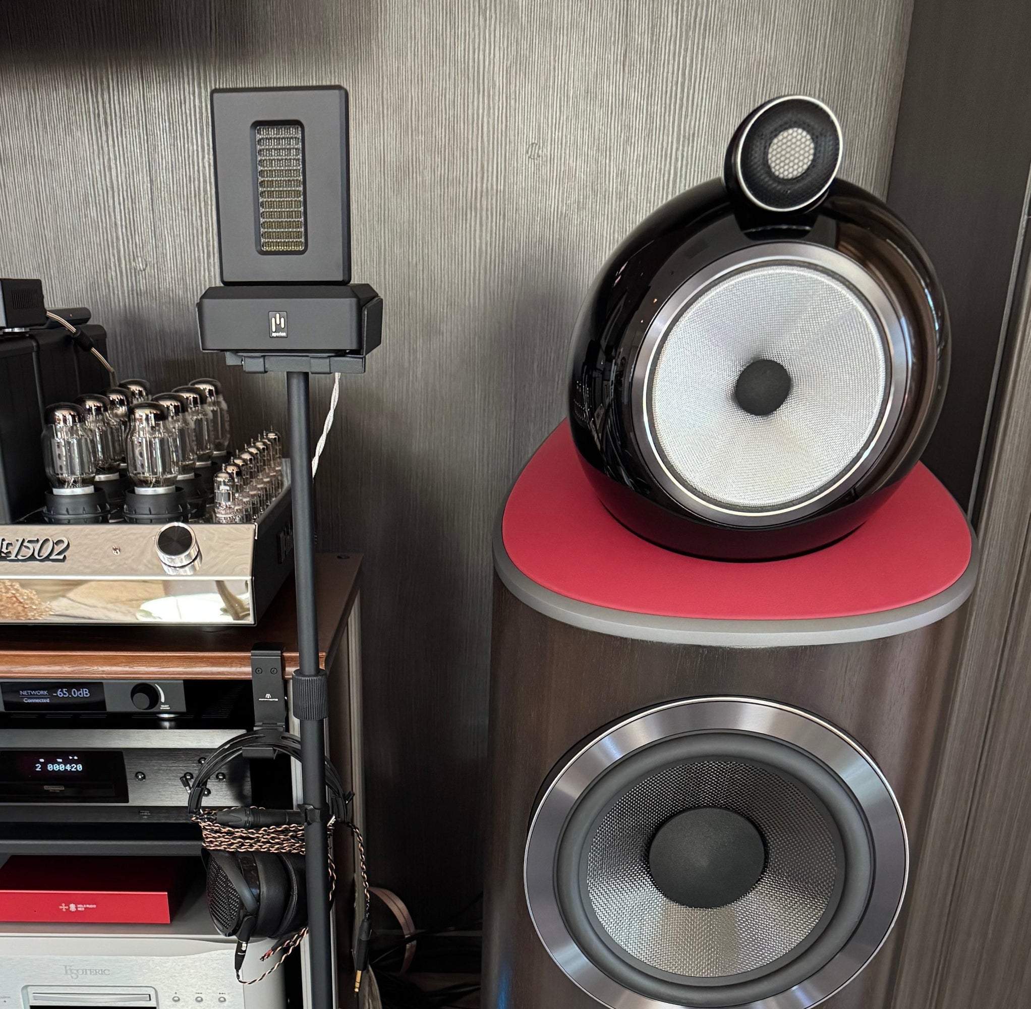 High-end audio equipment including speakers and amplifiers in a room setting.
